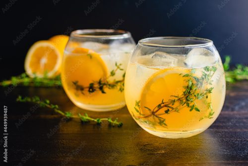 Meyer Lemon and Thyme Bees Knees Cocktails: Gin cocktails made with Meyer lemon juice and garnished with thyme sprigs and a slice of lemon