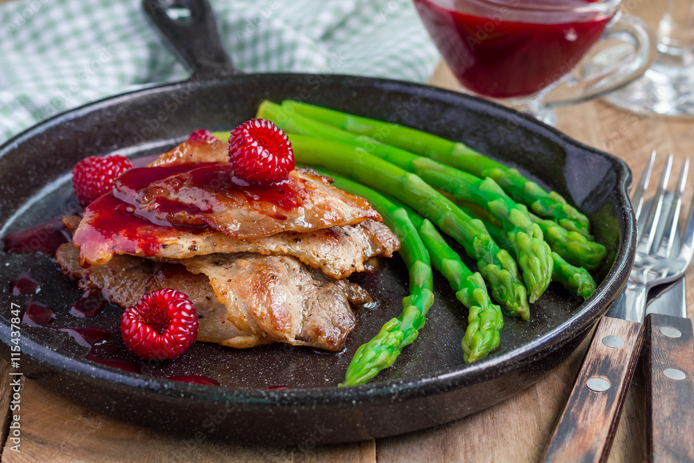 Pork cutlets with raspberry sauce and asparagus, horizontal